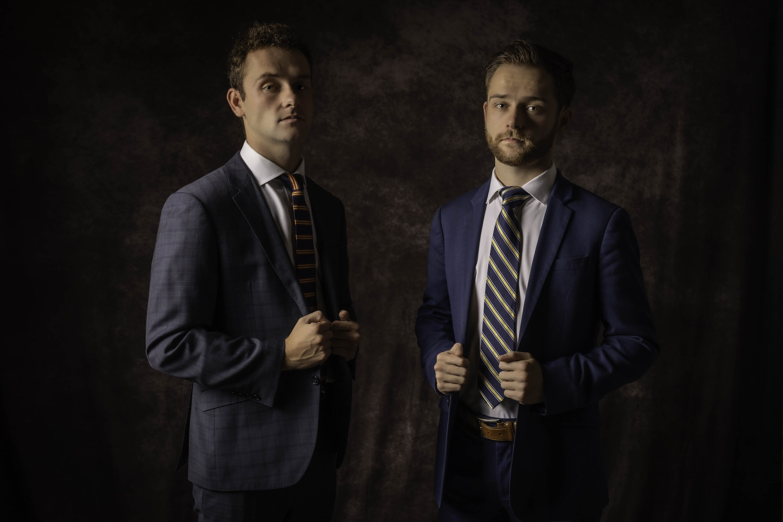 CT Photographer | Simsbury Senior Photos | Two high school twin senior boys dressed in dark suits with ties stand confidently for their Senior Portraits