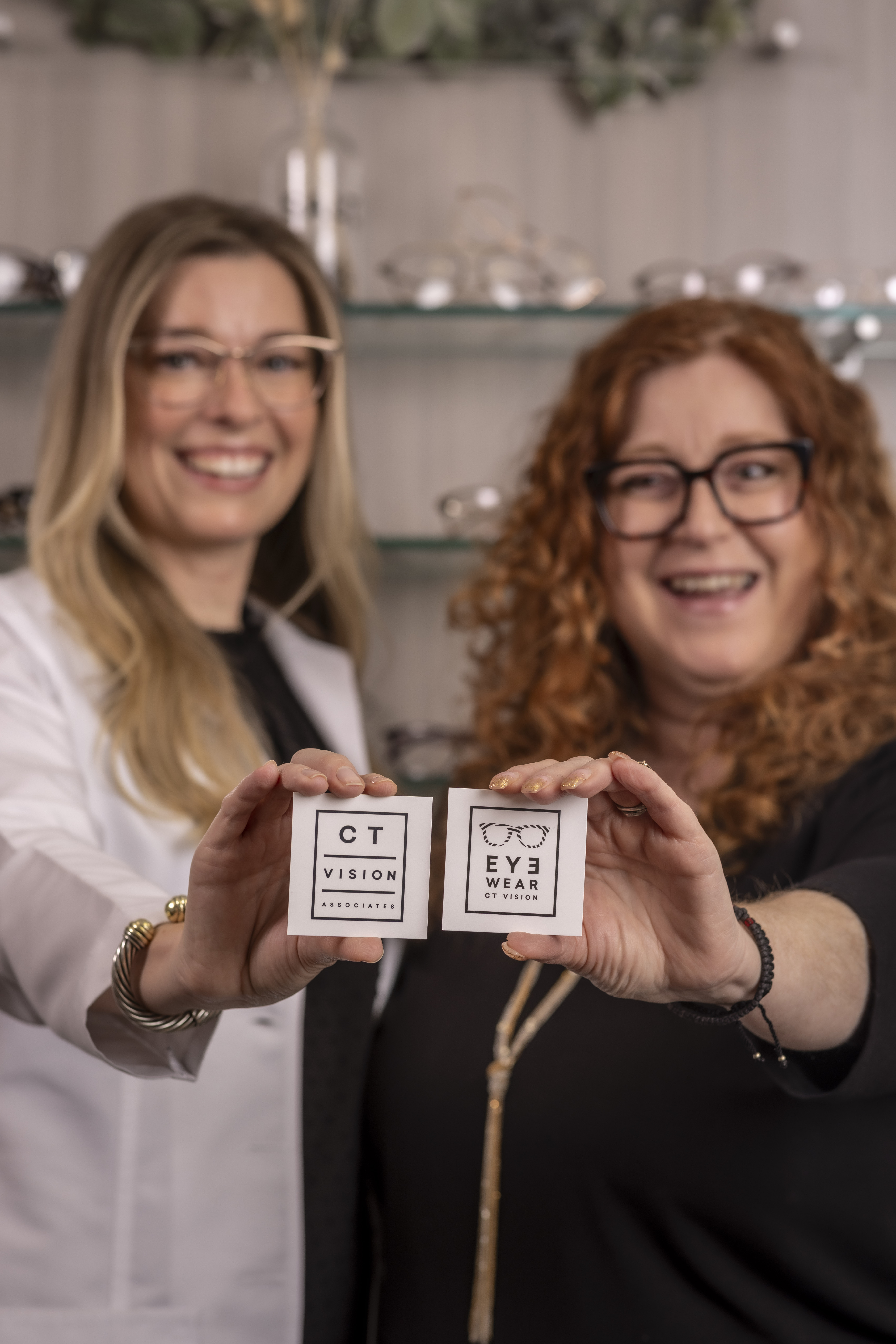Rob Faber Photography | Business Branding Photography | Branding CT | Two women holding branded candle products toward the camera during a business branding photography session, showcasing personality, connection, and intentional brand storytelling.