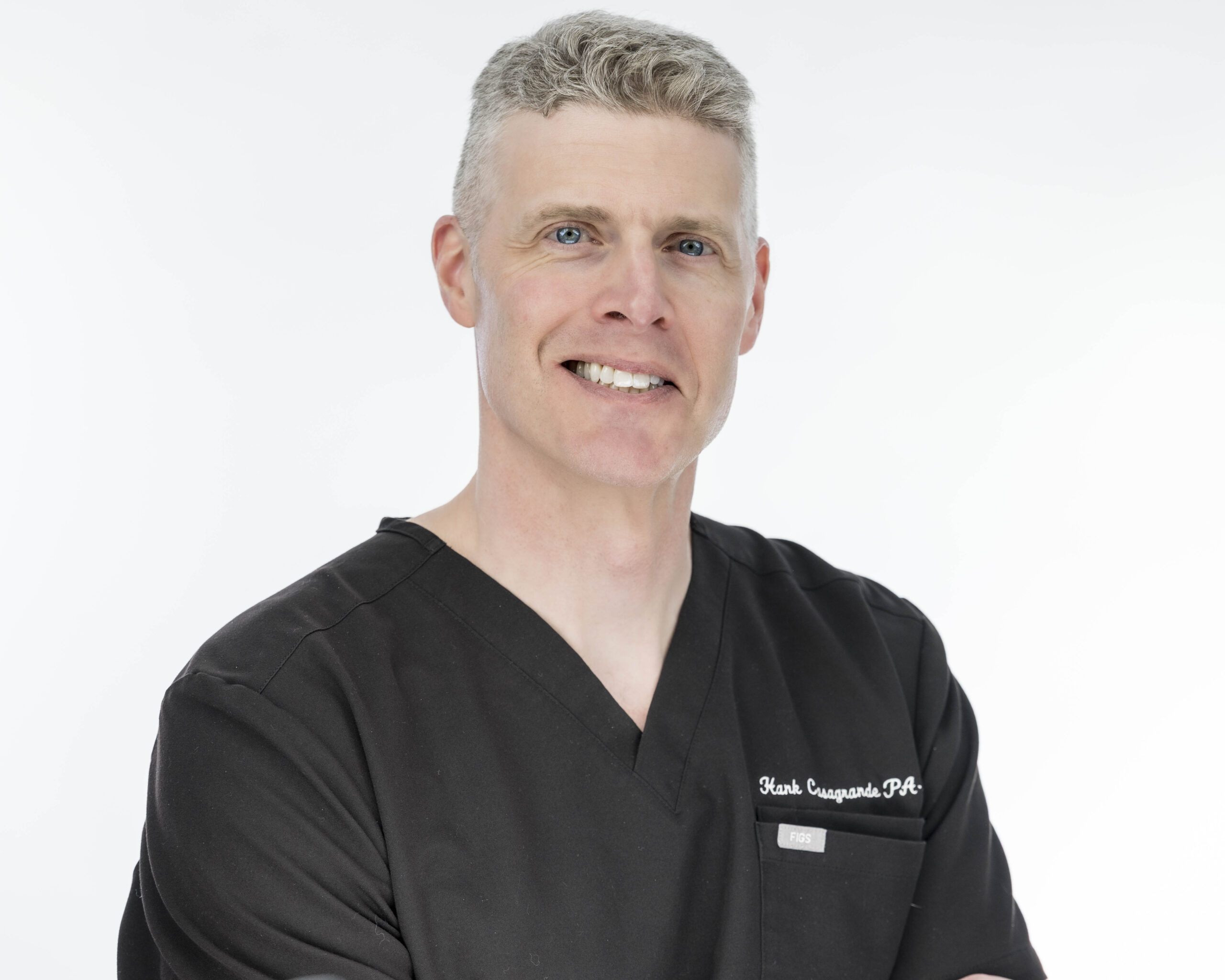 Vitality Health Professional, Hank Casagrande gets poses for his MA Professional Headshots in black medical scrubs with Rob Faber Photography in Longmeadow, MA