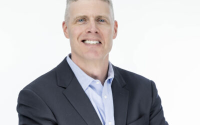 Professional headshots in CT of a confident male business professional wearing a dark suit jacket and light blue shirt, photographed against a clean white background with arms crossed to convey leadership, trust, and professionalism.