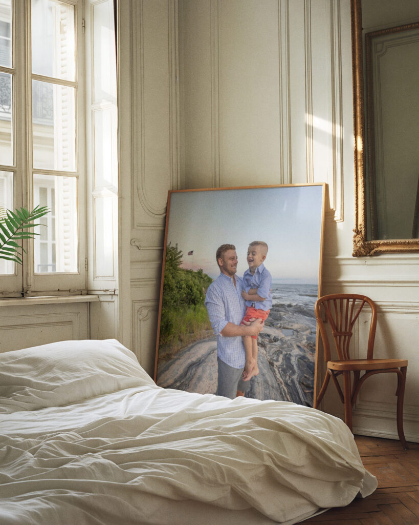 Father holds young son during his family photo session with Rob Faber Photography on. a beach in CT.