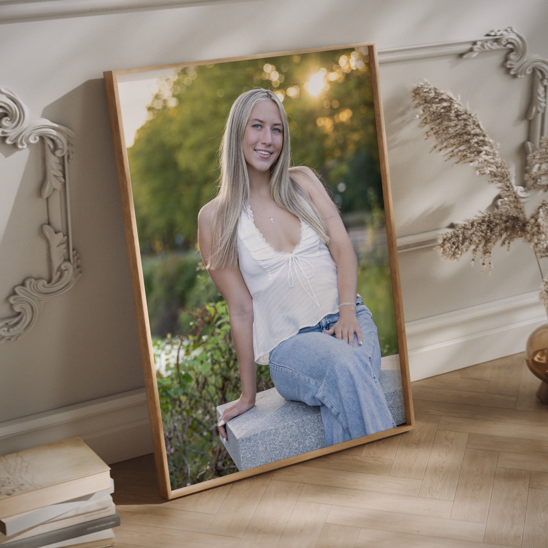 Photographer in West Hartford | Rob Faber Photography | Framed senior portrait of a young woman in a white top and jeans, displayed indoors as luxury wall art with natural light and elegant décor.