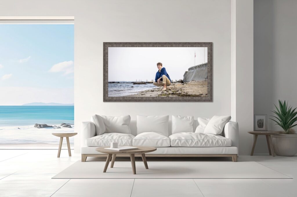 Photographer in Avon | Rob Faber Photography | Large framed wall art of a senior portrait displayed in a modern beachside living room.
