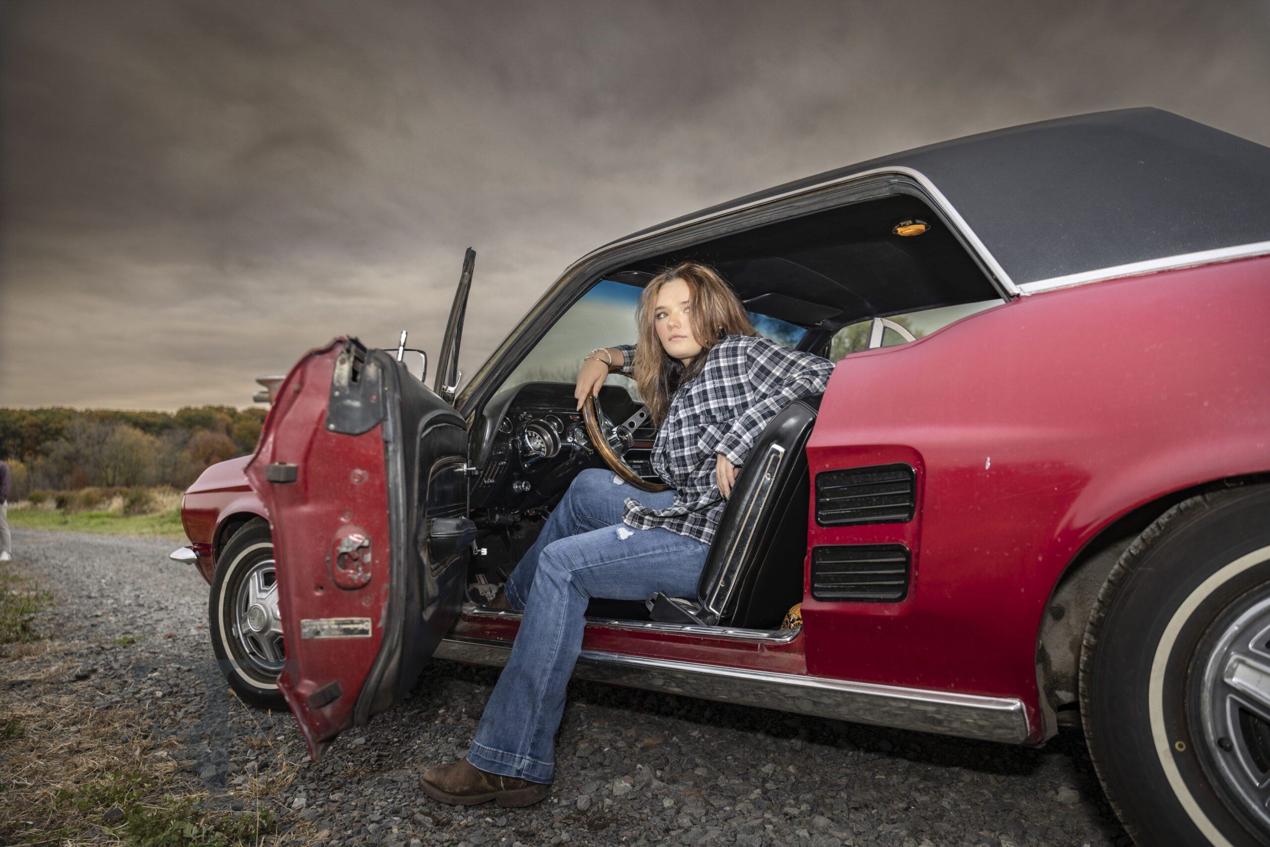 CT Senior Photographer | Senior girl sitting in classic red 1967 Ford Mustang during fine-art senior session in Suffield CT; cinematic portrait by Rob Faber Photography.