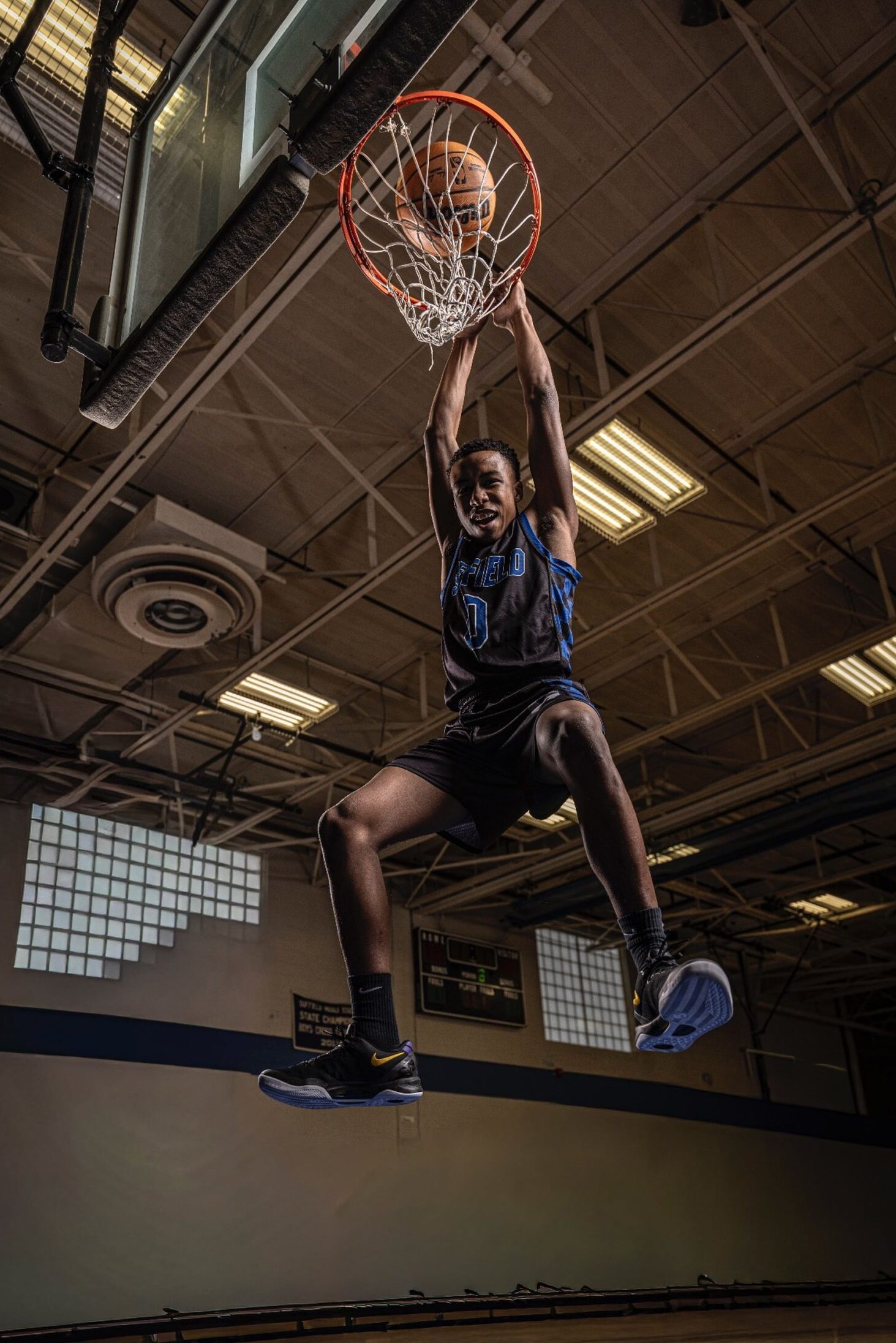 High school basketball media day action photo capturing a dunk during a professional media day session in CT