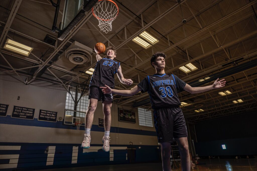 Rob Faber Photography | Media Day Photographer | What is a Media Day | Two high school basketball players captured mid-action in a gym during a professional media day, photographed with dramatic lighting to showcase athleticism, teamwork, and competitive energy.