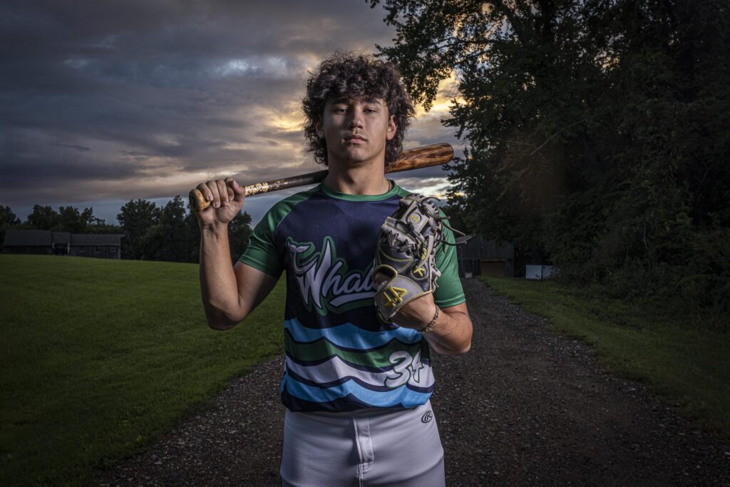 Rob Faber Photography | FBR Media | Senior Guys Portraits | High school baseball player holding a bat over his shoulder during an outdoor athletic senior session in Connecticut