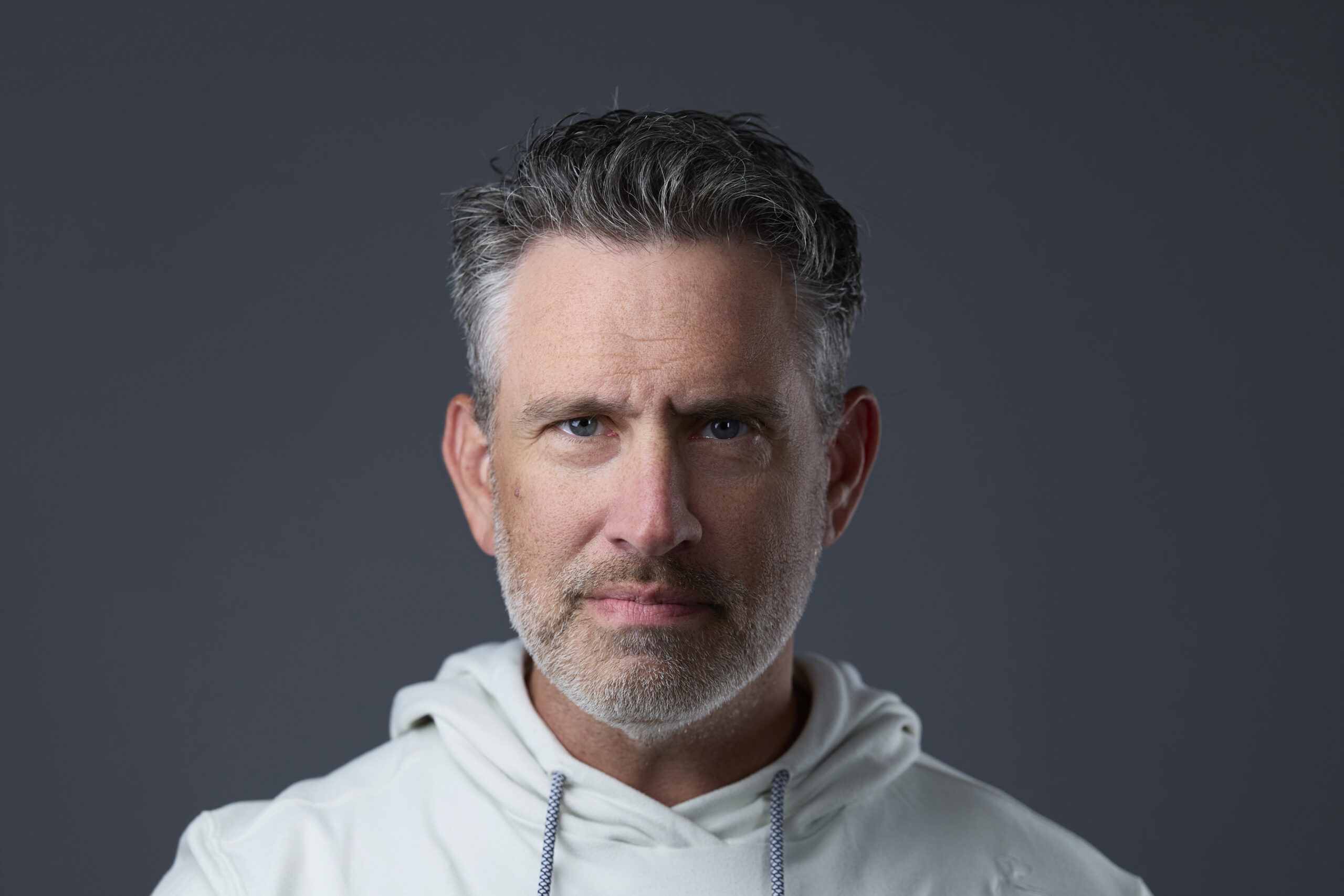 Rob Faber Photography | Headshot Portrait | Rob Faber in White hoodie posing for slef portrait.